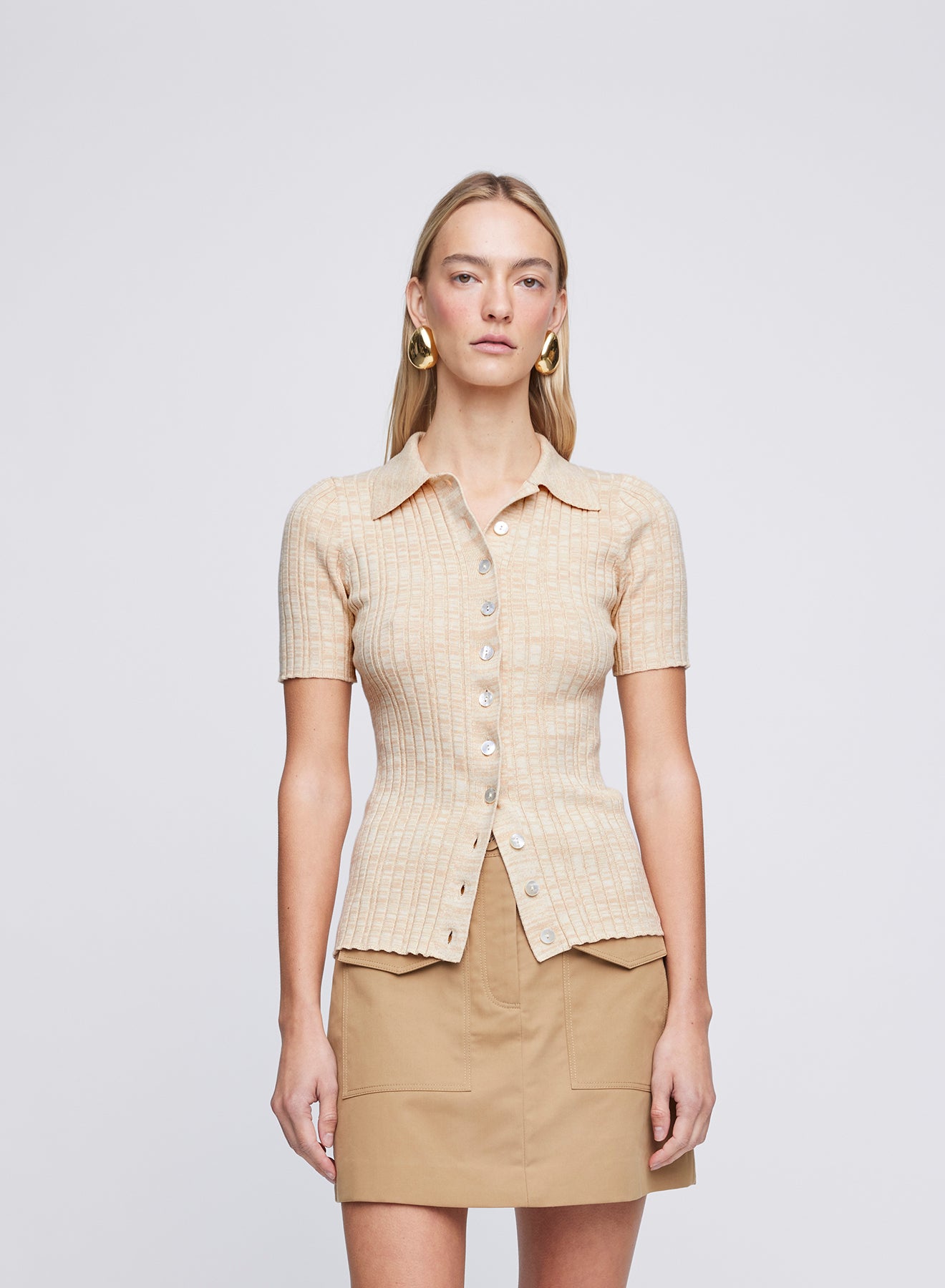 The Anna Quan Avi Top in Sand Dune is a classic polo knit, with a collar and button down placket.