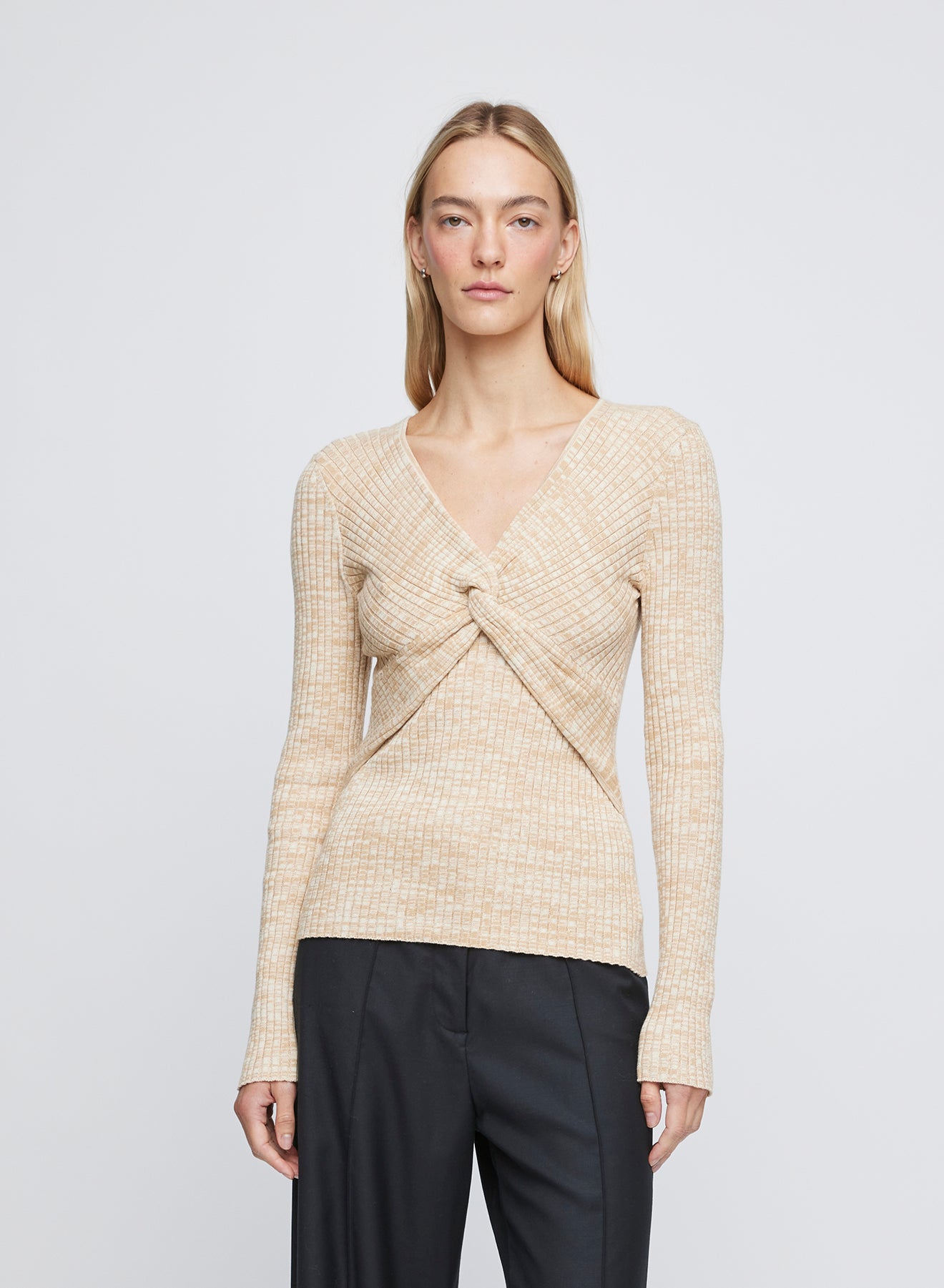 The ANNA QUAN Luna Top in Sand Dune is a long sleeve knit featuring a centre front twist and deep v neckline.