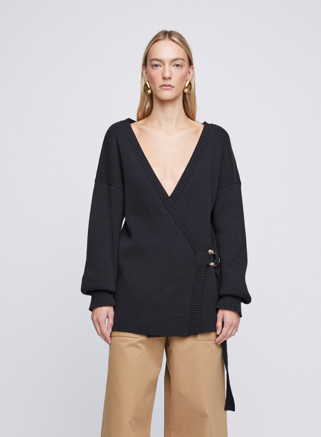 The Anna Quan Bridget Cardigan in Silence is a classic long sleeve knitted cardigan with a belt closure and deep v cut neckline.