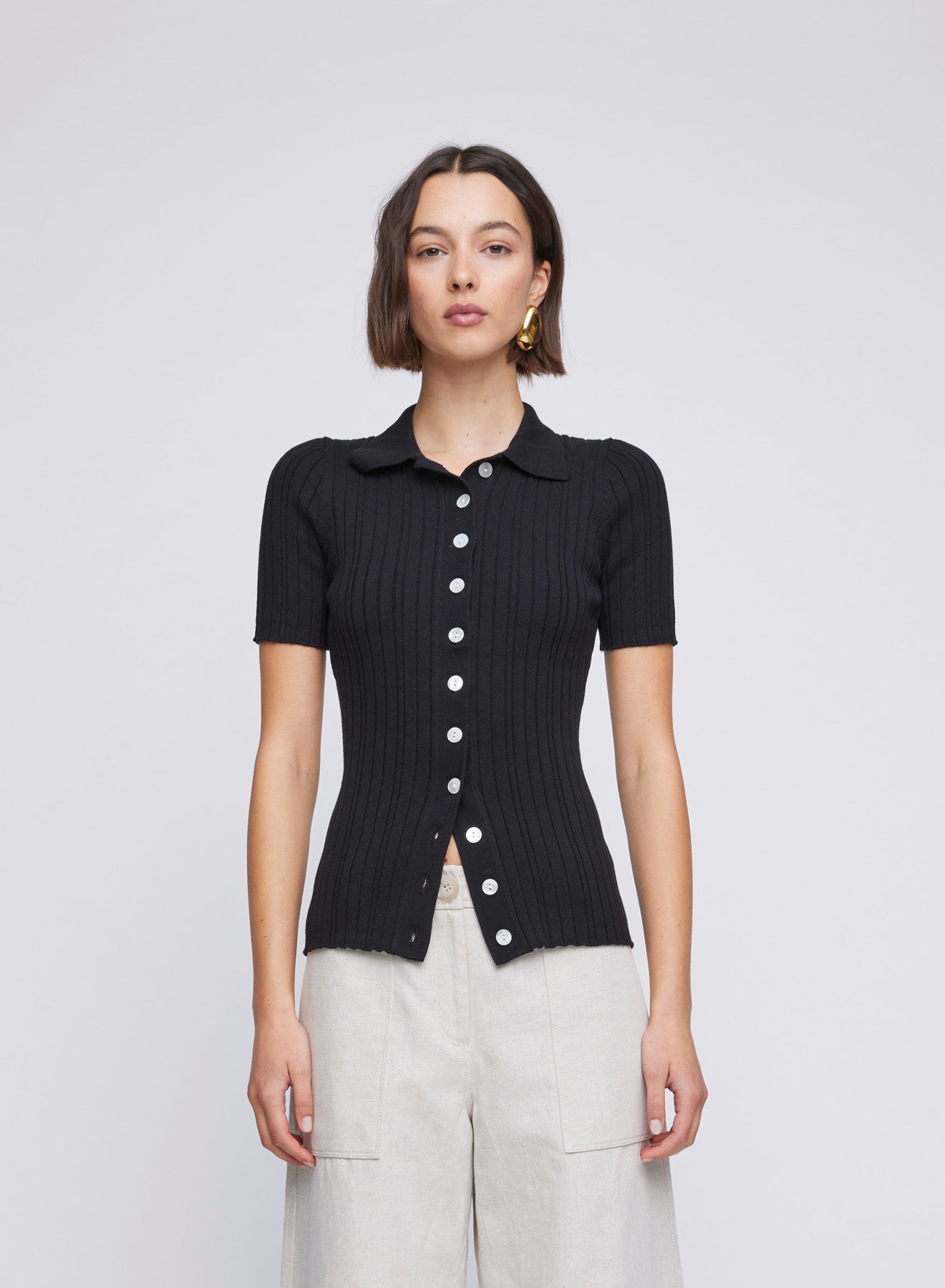 Rib knit short sleeve polo top top with contrast button up. Black knit top, black short sleeve knit top, casual everyday top, casual top, casual knit top.