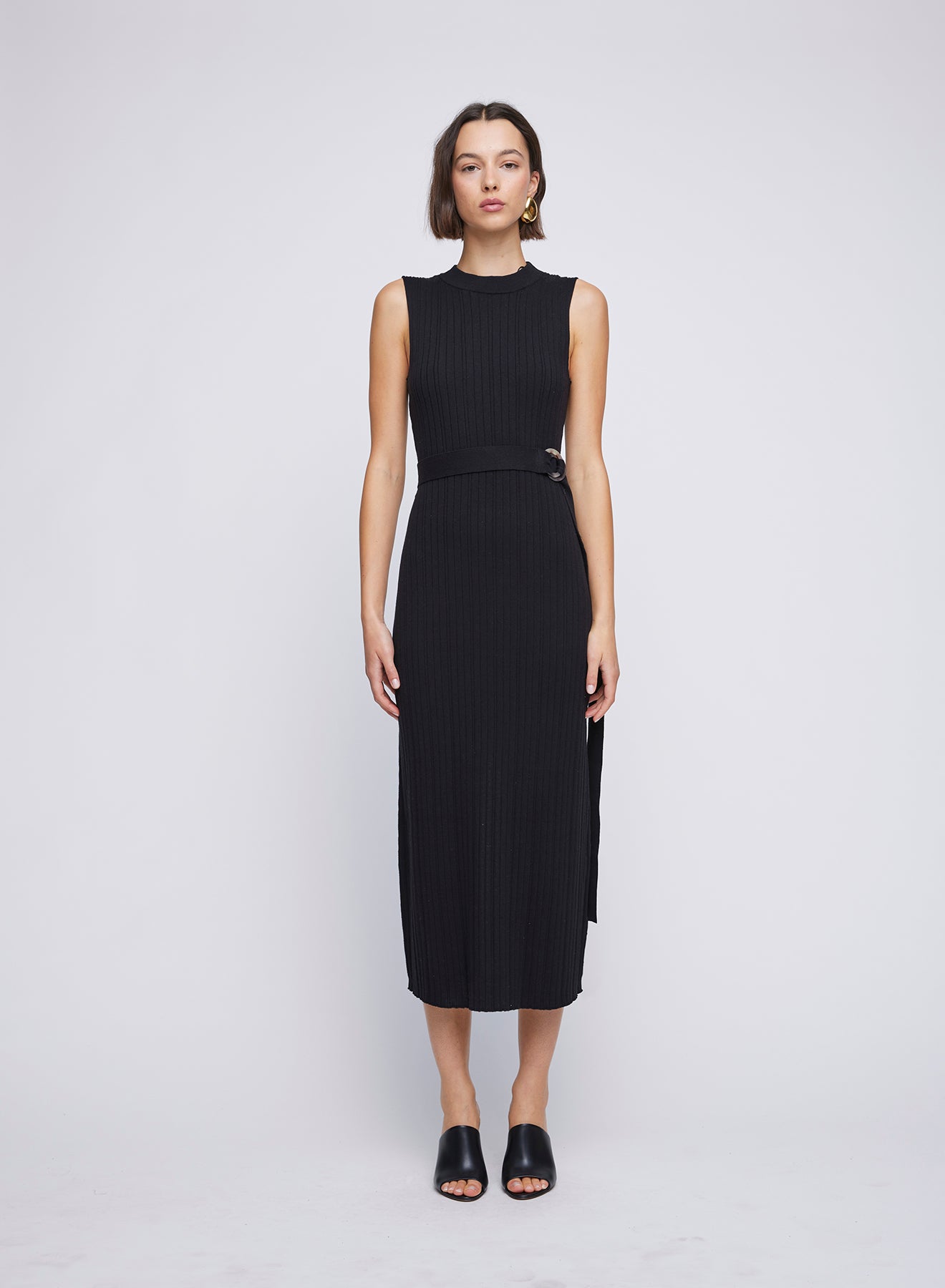 ANNA QUAN Sleeveless Crew Neck Dress with ring belt detail. Effortlessly chic, this dress is perfect for any occasion. The modern design and flattering silhouette make it a versatile wardrobe essential. Midi knit dress, everyday knit dress, everyday sleeveless knit dress with waist belt and ring loop.