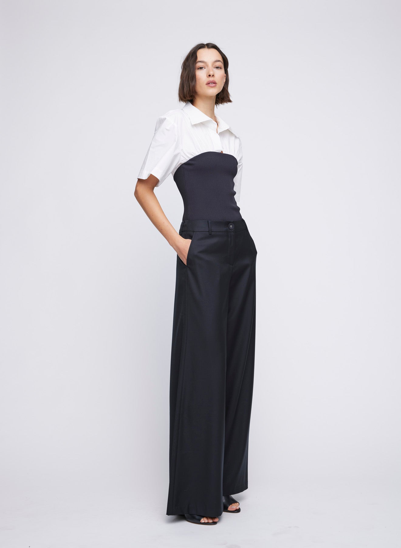 ANNA QUAN's wardrobe staple Wide Leg Tailored Pants, feature a classic button, zip fastening and belt loops. Designed to sit on the waist and the leg hem skimming the floor. Tailored pants, work pants, everyday pants, black work pants, tailored wool pants.