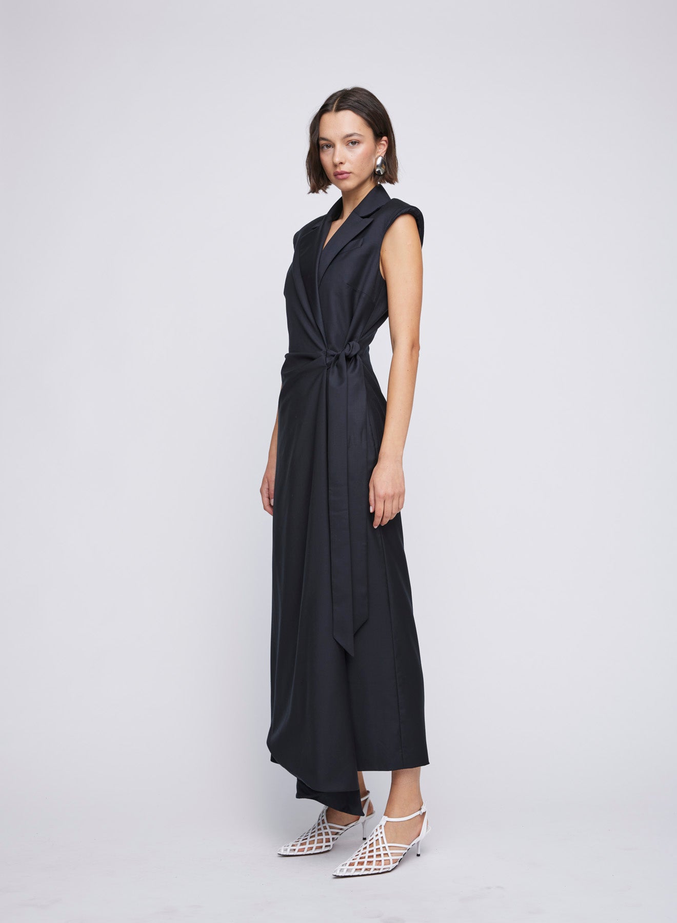 ANNA QUAN Victoria Dress in wrap tailored style. Waist-cinching tie, shoulder pads, v neckline. Ideal for an elegant office-to-dinner ensemble.