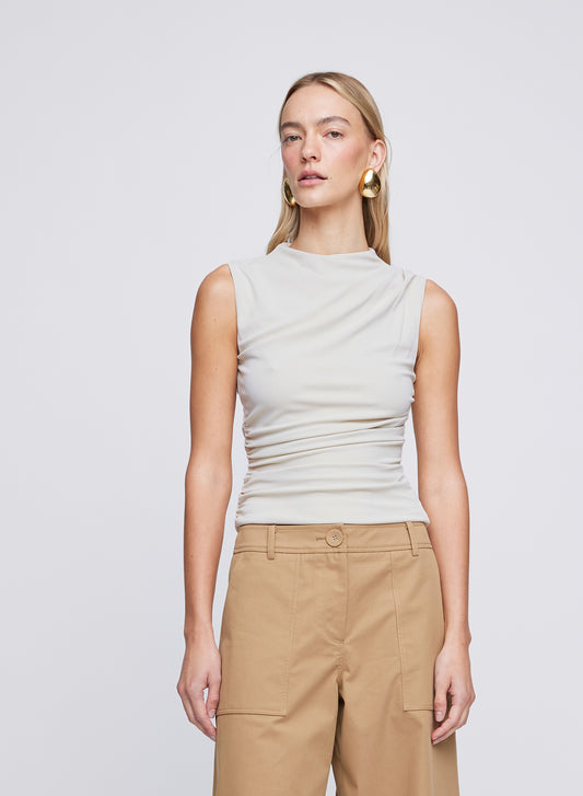 The ANNA QUAN Ursula Top in Dove is a wardrobe staple, crafted in a jersey stretch material featuring a slight funnel neckline and waist ruching detail.
