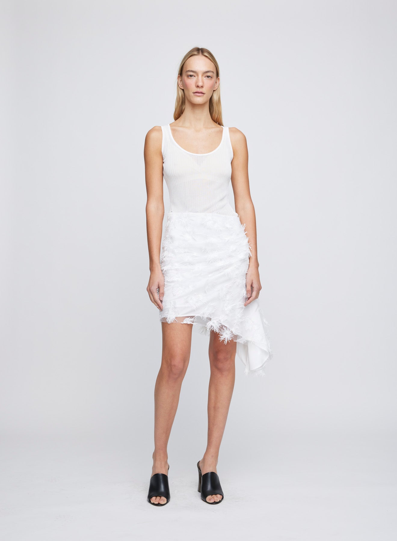 The ANNA QUAN Faye Skirt in Dandelion is an asymmetrical mini skirt crafted in our premium applique fabric 